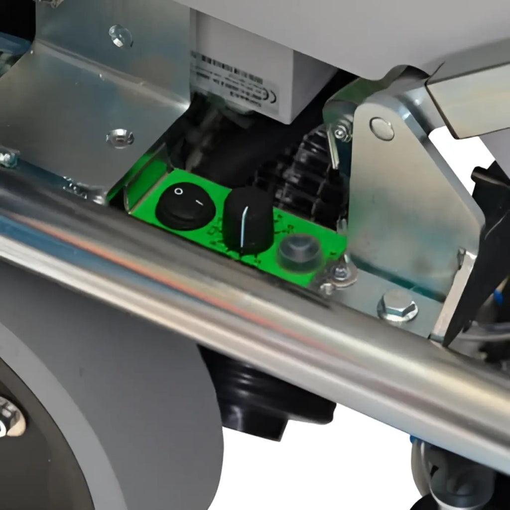 Green control panel with black knobs and gray buttons on wetrok drivematic delarge dosing scheuersaugmaschine