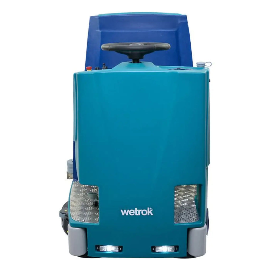 Wetrok drivematic delarge dosing scheuersaugmaschine mit türkisblauem gehäuse, schwarzem lenkrad und rutschfesten diamantplatten